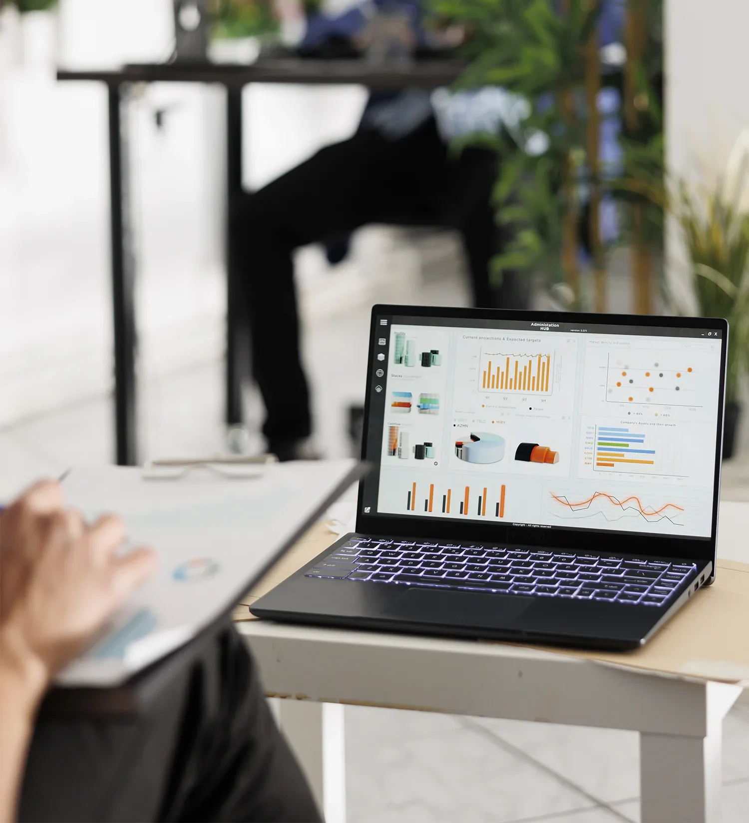 A workspace with a laptop showing SEO analytics and Growth graphs.