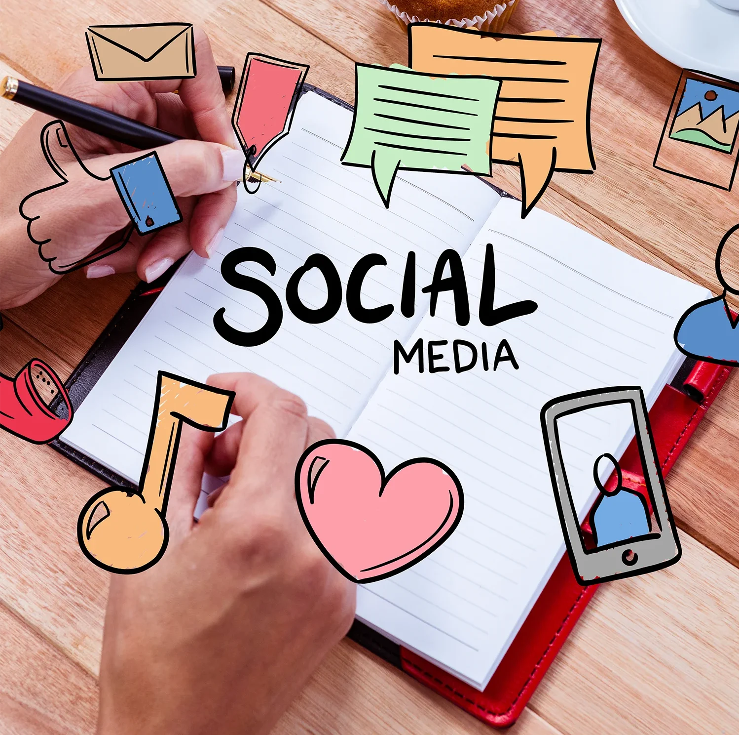 Hands planning social media strategies with doodles in a notebook for audience approach